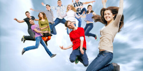 Happy teenage friends jumping in the sky